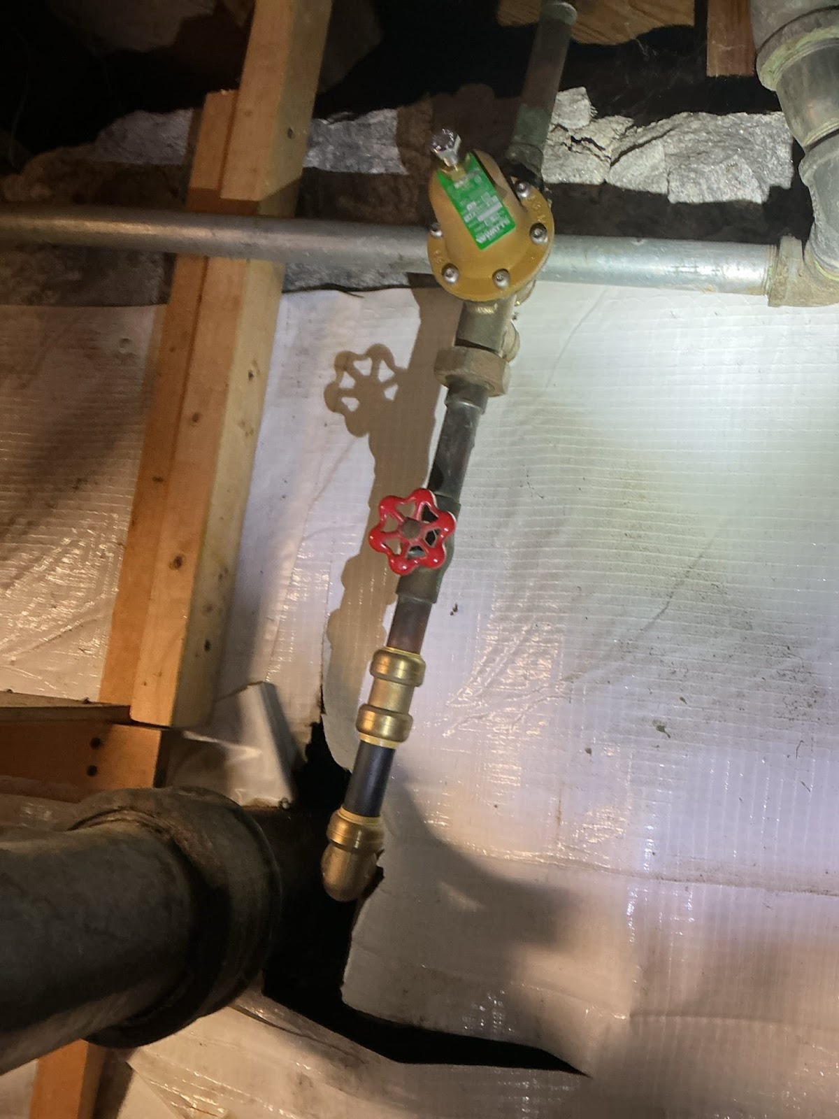 PlumbingPro North Atlanta — crawlspace gas-line shutoff valve with new solenoid and brass fittings above the vapor barrier